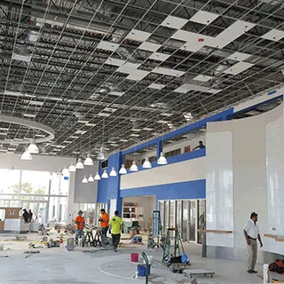 A commercial interior under construction, its ceiling grid open