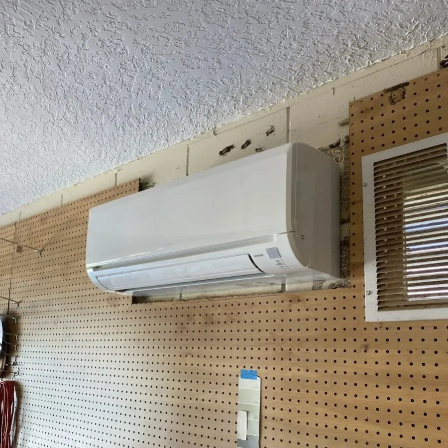 A mini-split head mounted on a garage wall